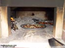 Fire embers in wood oven made of bricks.