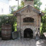 Front of a pizza oven with field stones.