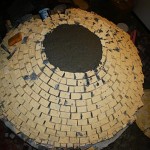 Constructing igloo firebricks pizza oven.