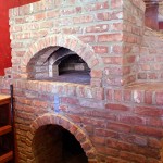 Pizza shops round cylindrical pizza oven.