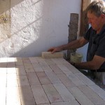 The last firebrick in laying the oven hearth.