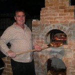 Making pizzas in outdoors pizza oven.