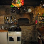 Oven with dome made out of stones in an old kitchen. 