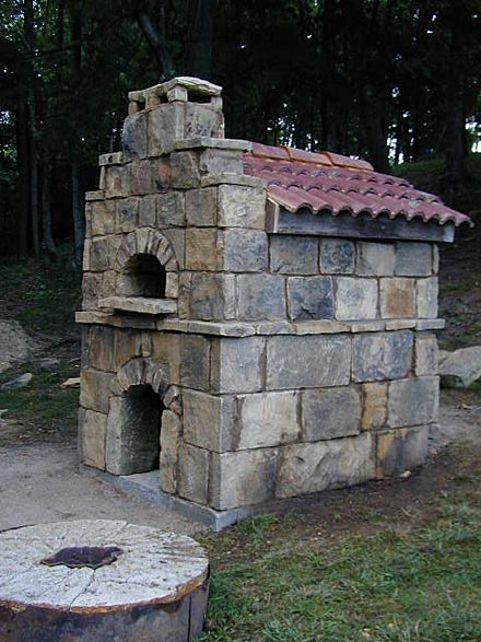 Stone outer walls on garden pizza oven.