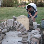 Building walls with re-used cut field stone.