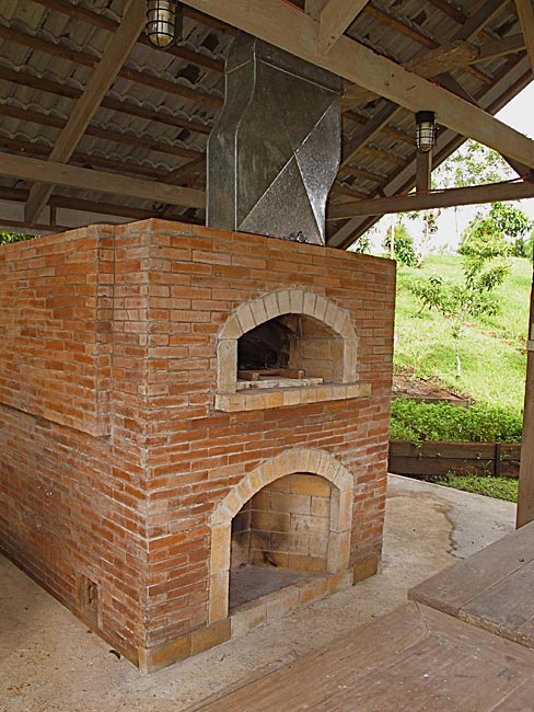 Mto brick oven with fireplace under a hut