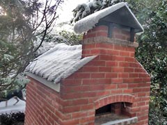 Snow on cottage oven