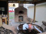 Oven built high above ground with wood deck level