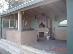 Oven entrance indoors and actual oven outdoors behind wall