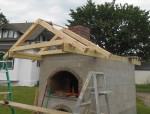 Roof frame for covering oven front