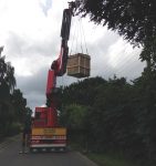 The crane truck lifting the masonry structure