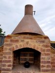 Artistic chimney worked from metal and bricks.